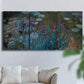 Three-panel canvas wall art featuring water lilies on reflective pond, displayed in a living room above a sofa.