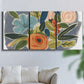 Three-panel canvas wall art featuring colorful botanical illustration, displayed in a living room above a sofa.