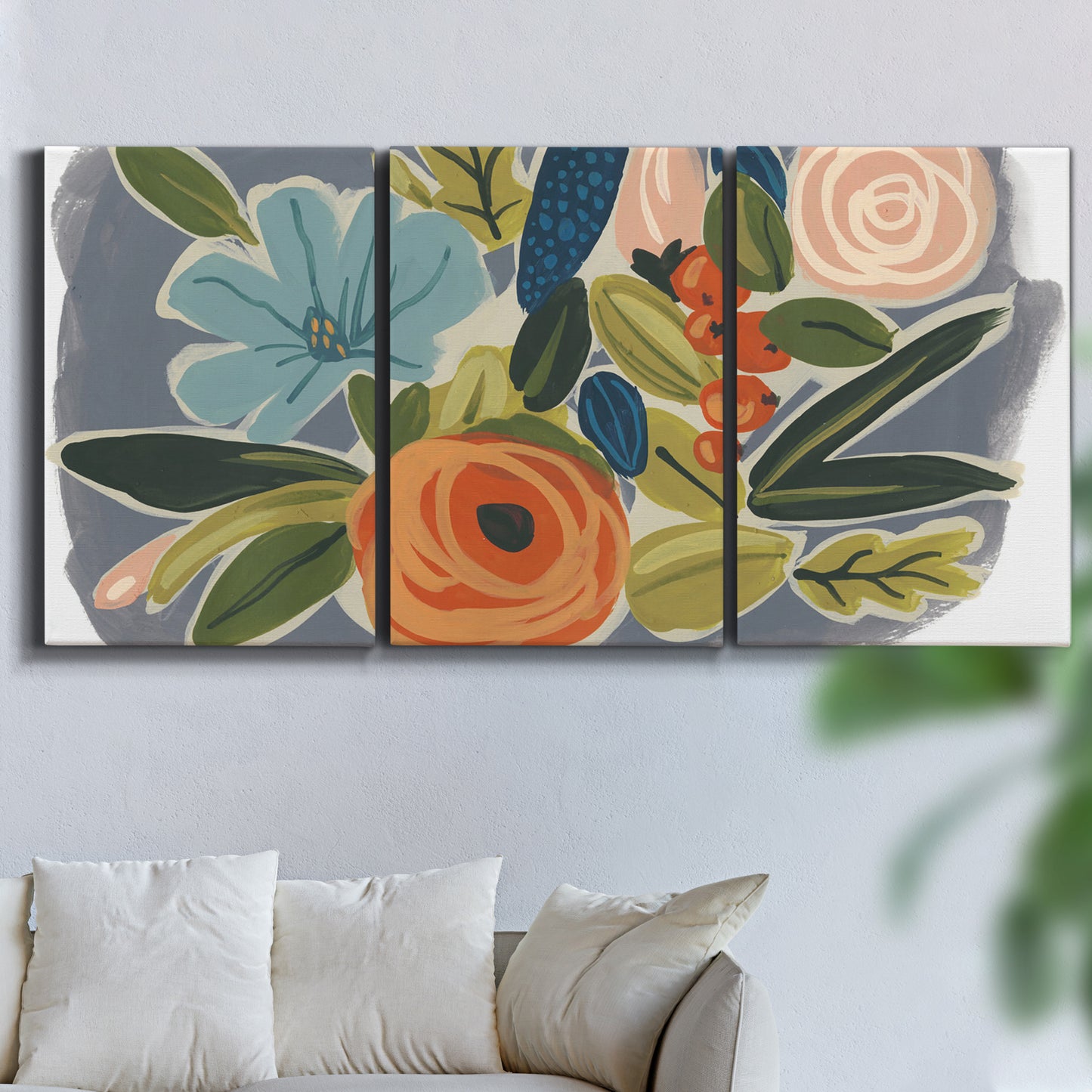 Three-panel canvas wall art featuring colorful botanical illustration, displayed in a living room above a sofa.