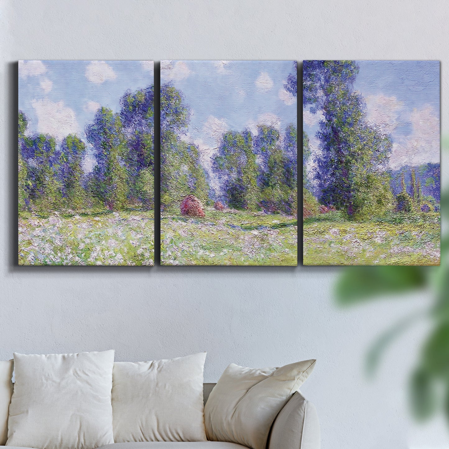 Three-panel canvas wall art featuring poppy field near garden village, displayed in a living room above a sofa.