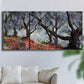 Three-panel canvas wall art featuring pine trees silhouetted at evening, displayed in a living room above a sofa.
