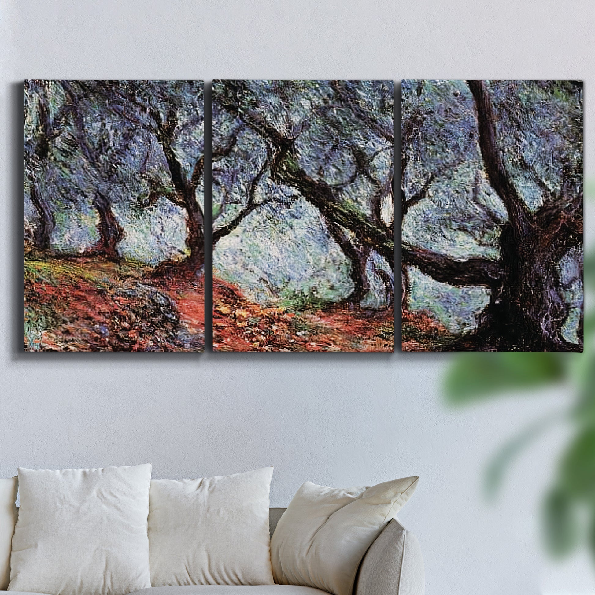 Three-panel canvas wall art featuring pine trees silhouetted at evening, displayed in a living room above a sofa.