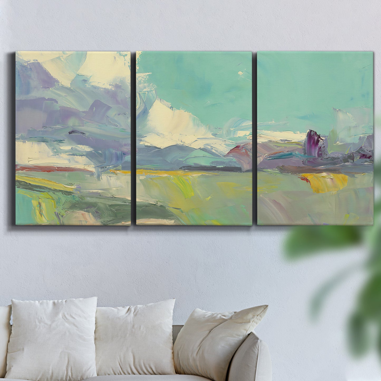 Three-panel canvas wall art featuring road stretching through open countryside, displayed in a living room above a sofa.