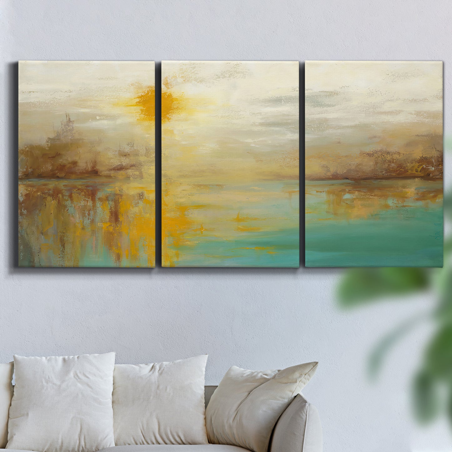 Three-panel canvas wall art featuring warm abstract end of summer palette, displayed in a living room above a sofa.