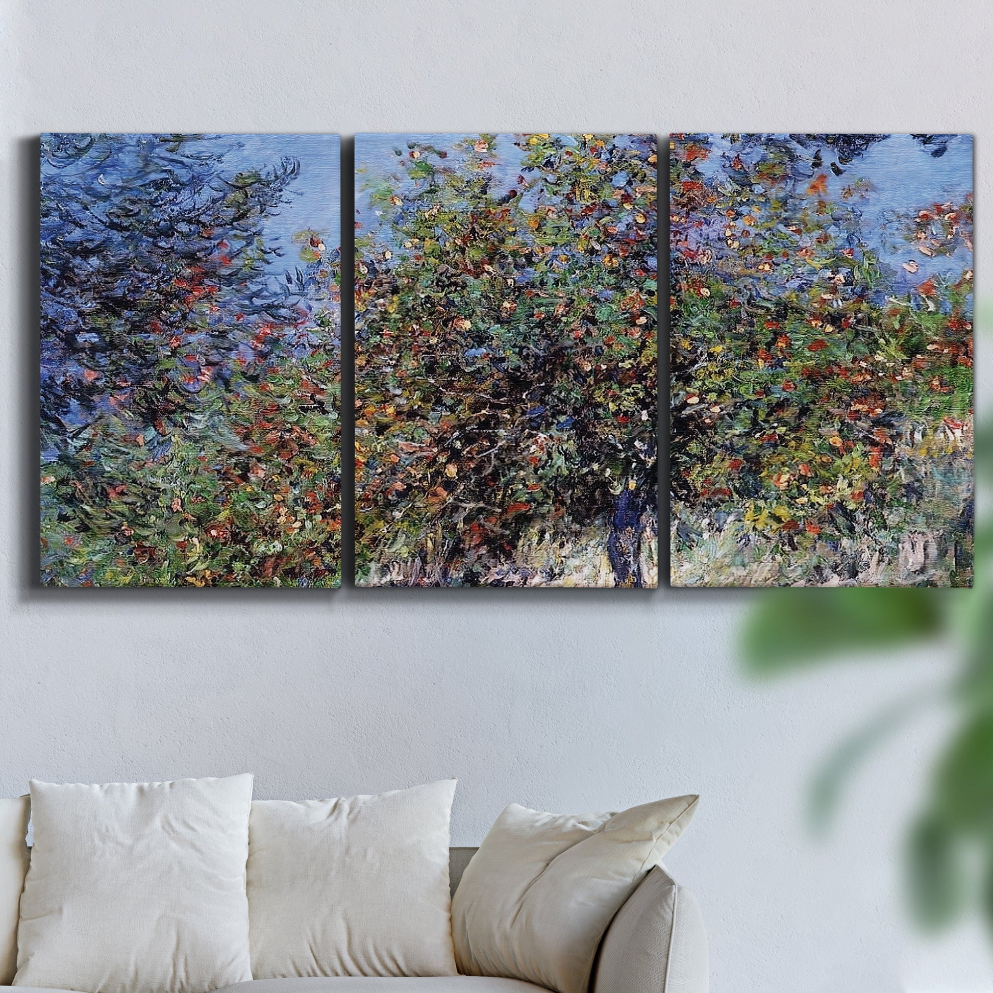 Three-panel canvas wall art featuring orchard of trees in spring bloom, displayed in a living room above a sofa.