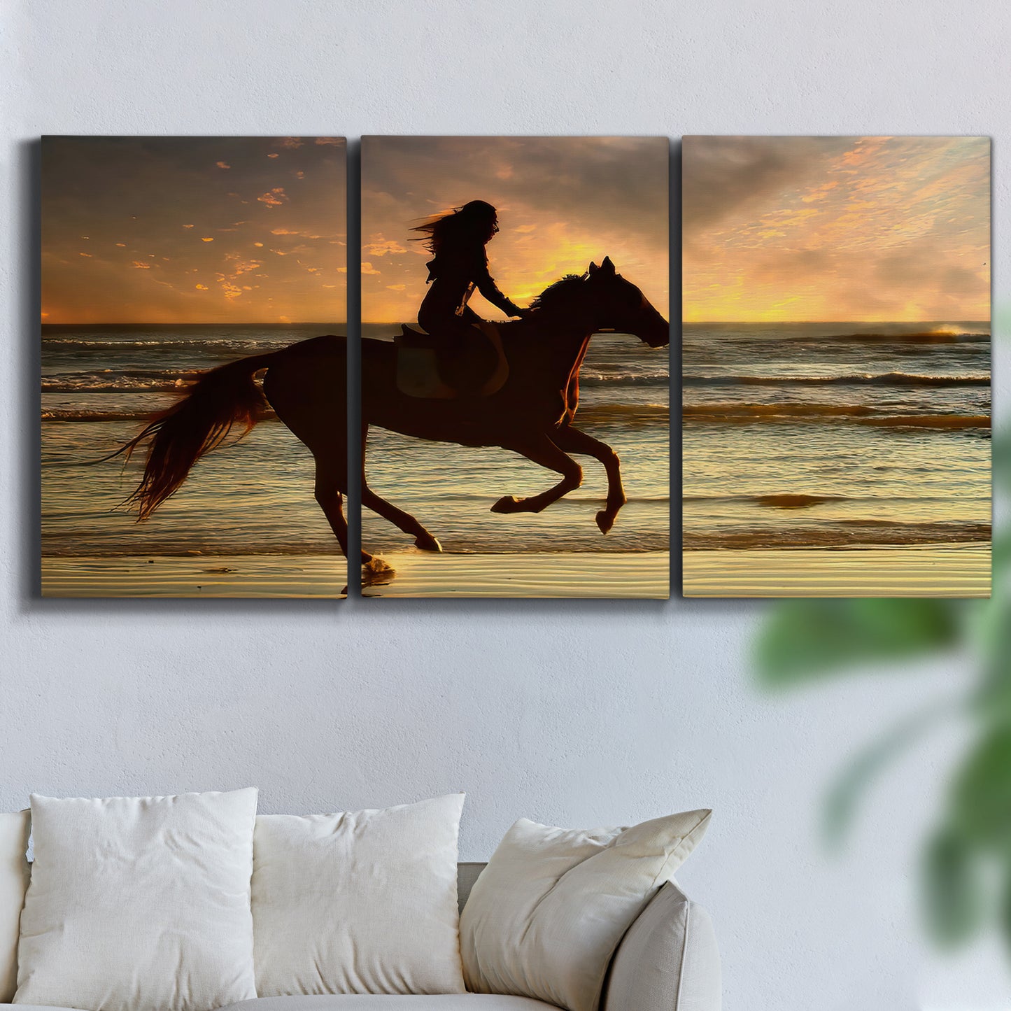 Three-panel canvas wall art featuring running horse along beach photograph, displayed in a living room above a sofa.