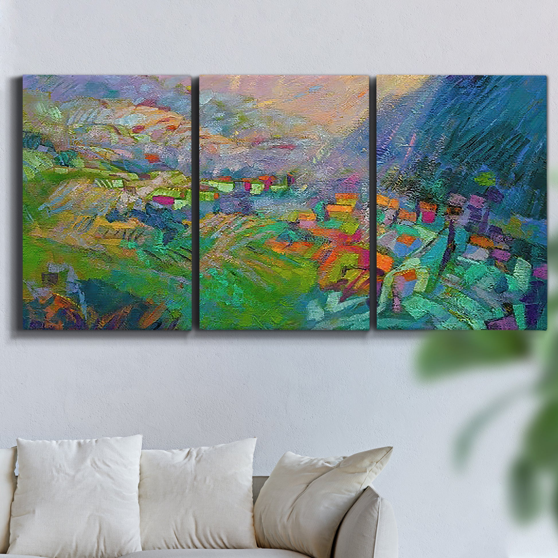 Three-panel canvas wall art featuring embracing landscape with warm tones, displayed in a living room above a sofa.