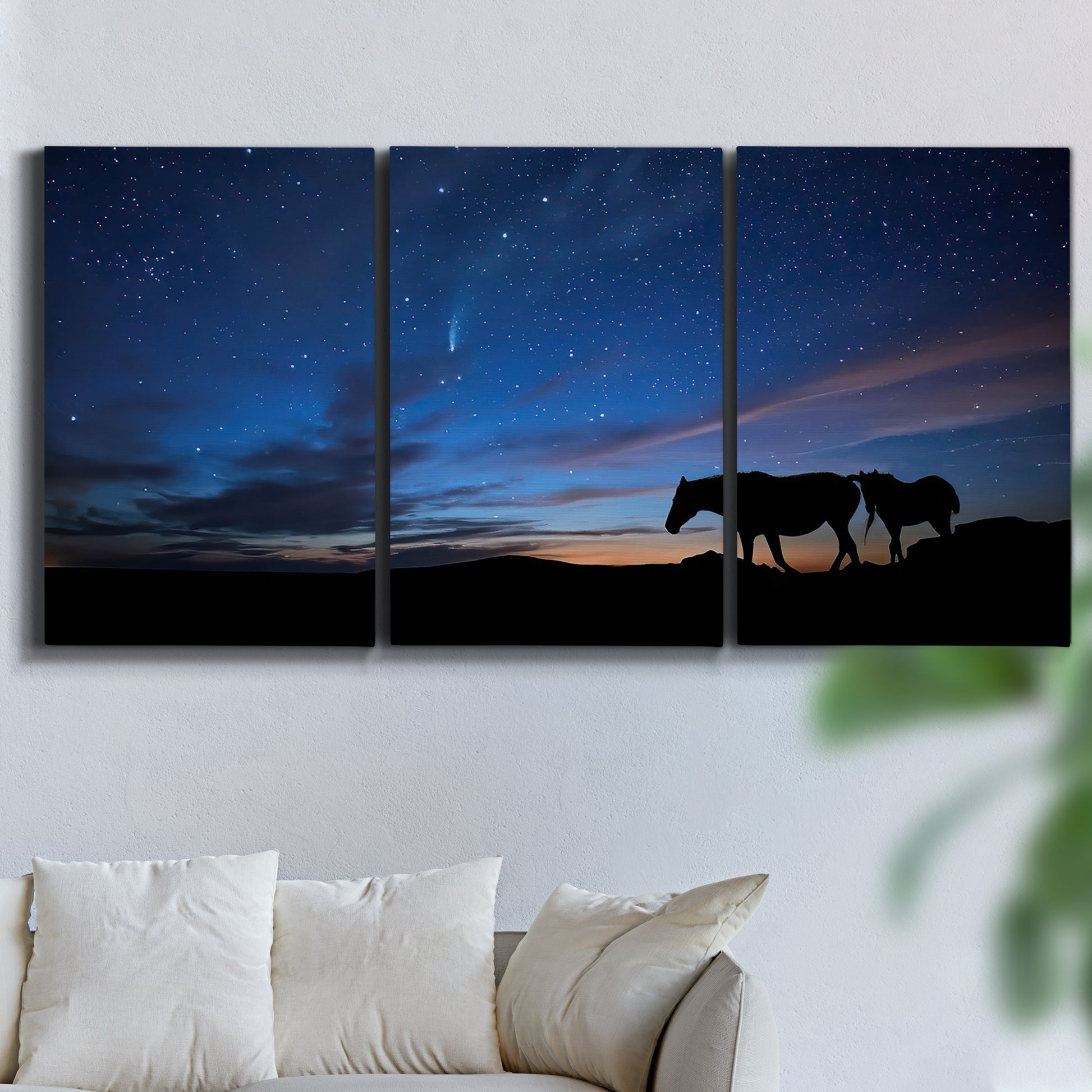 Three-panel canvas wall art featuring resting animals in open field, displayed in a living room above a sofa.