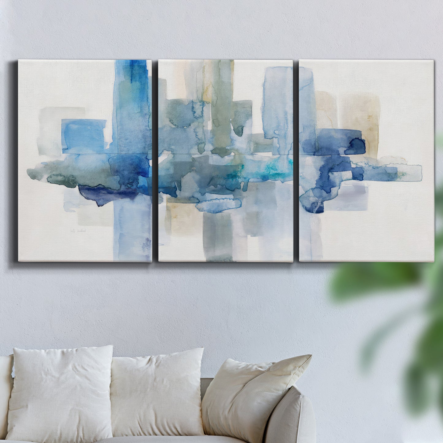 Three-panel canvas wall art featuring minimal urban skyline watercolor, displayed in a living room above a sofa.