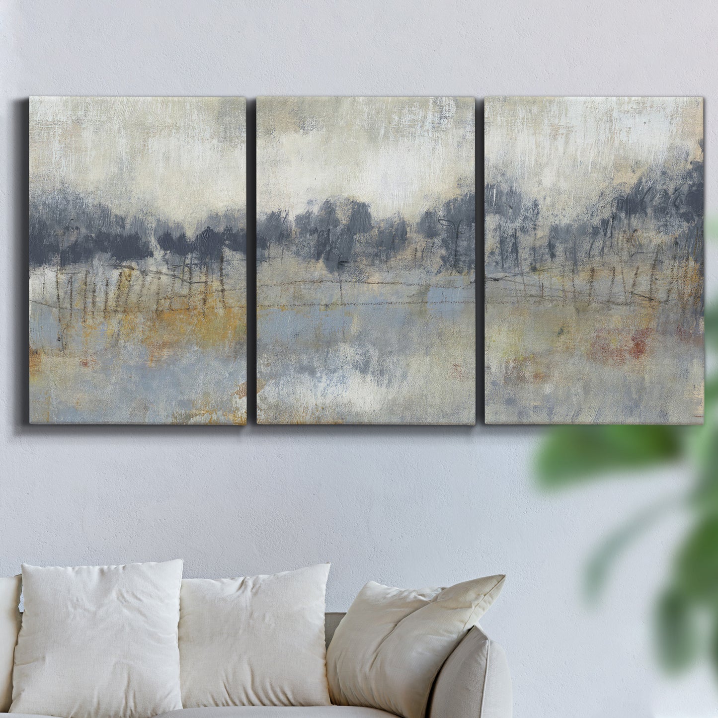 Three-panel canvas wall art featuring soft grey abstract horizon, displayed in a living room above a sofa.