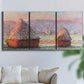 Three-panel canvas wall art featuring winter grainstacks glowing at sunset, displayed in a living room above a sofa.
