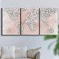 Three-panel canvas wall art featuring stylized pink cheetah world map, displayed in a living room above a sofa.