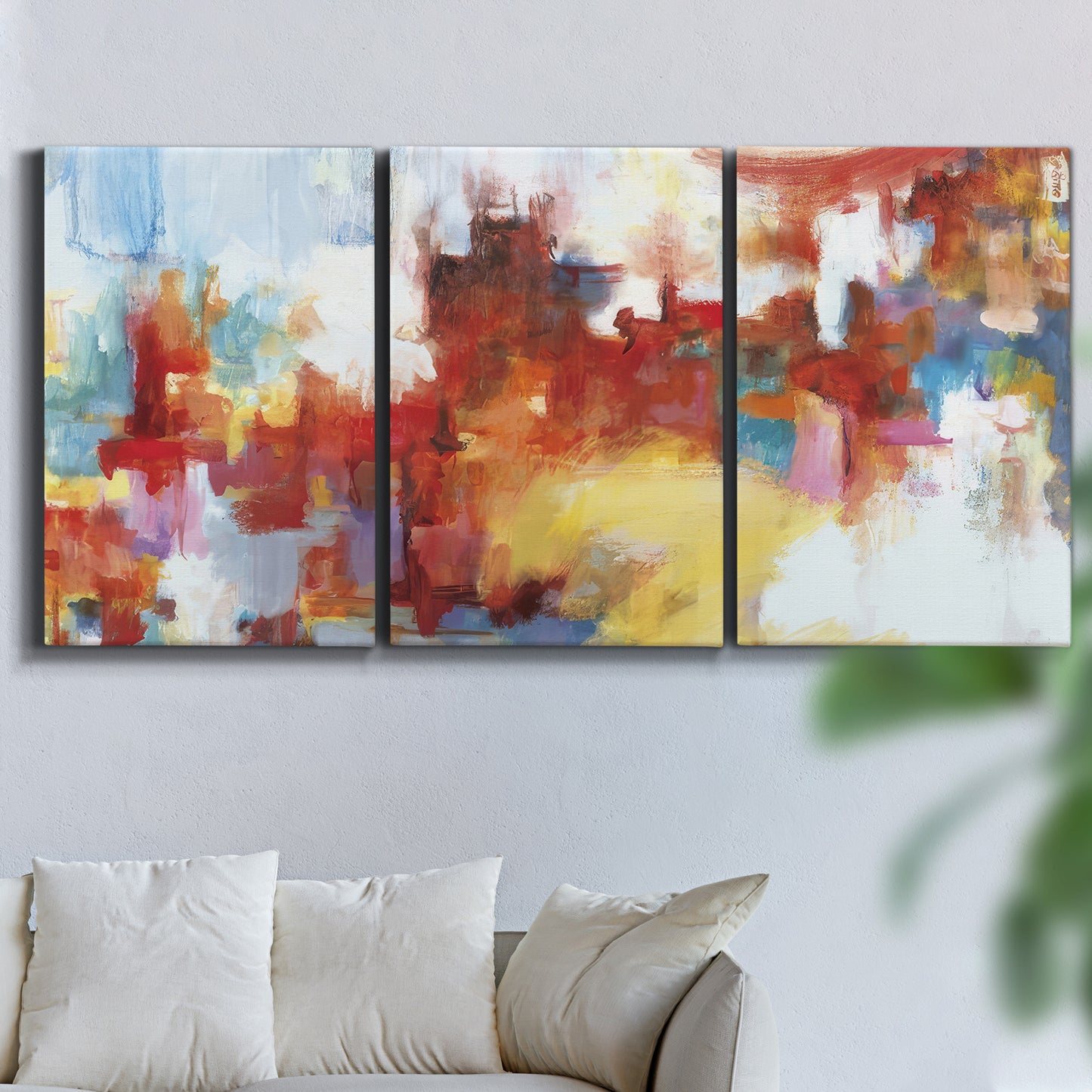 Three-panel canvas wall art featuring abstract city lights composition, displayed in a living room above a sofa.