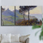 Three-panel canvas wall art featuring village church at sunset, displayed in a living room above a sofa.