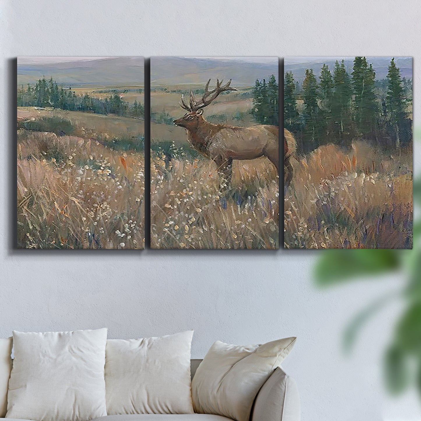 Three-panel canvas wall art featuring western wildlife standing in grassland, displayed in a living room above a sofa.