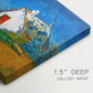 Canvas art print of white cottages grouped together with bold colors and surrounding landscape, highlighting texture and gallery-wrapped edges