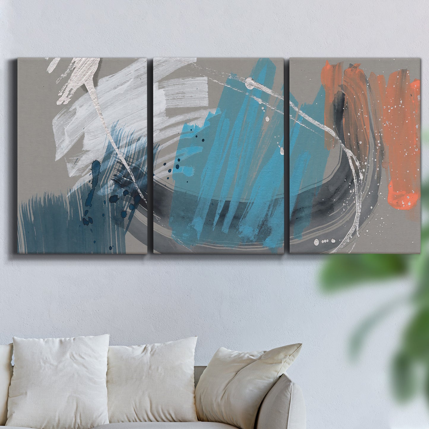 Three-panel canvas wall art featuring playful abstract mark making, displayed in a living room above a sofa.
