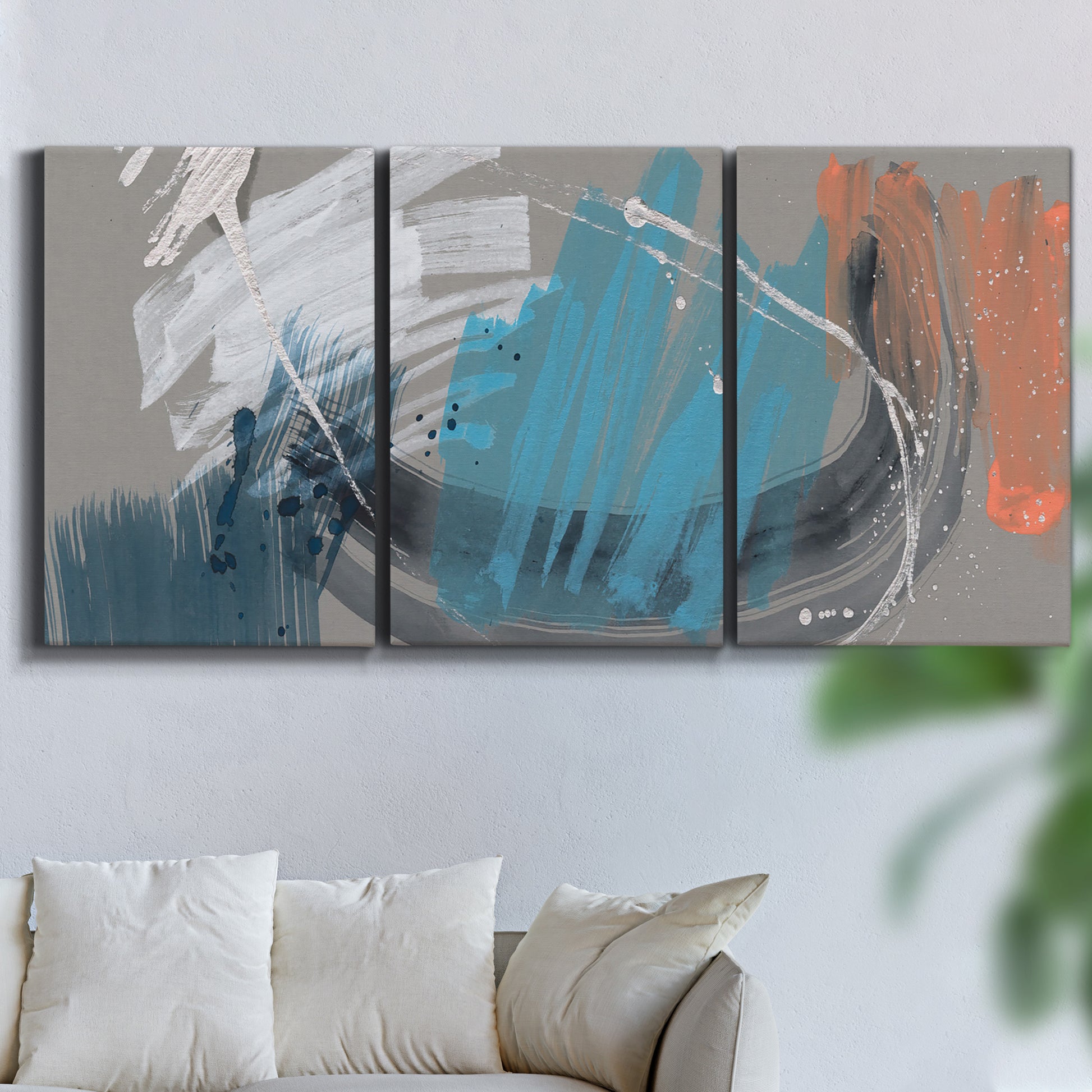 Three-panel canvas wall art featuring playful abstract mark making, displayed in a living room above a sofa.