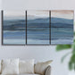 Three-panel canvas wall art featuring wide lake with distant shoreline, displayed in a living room above a sofa.