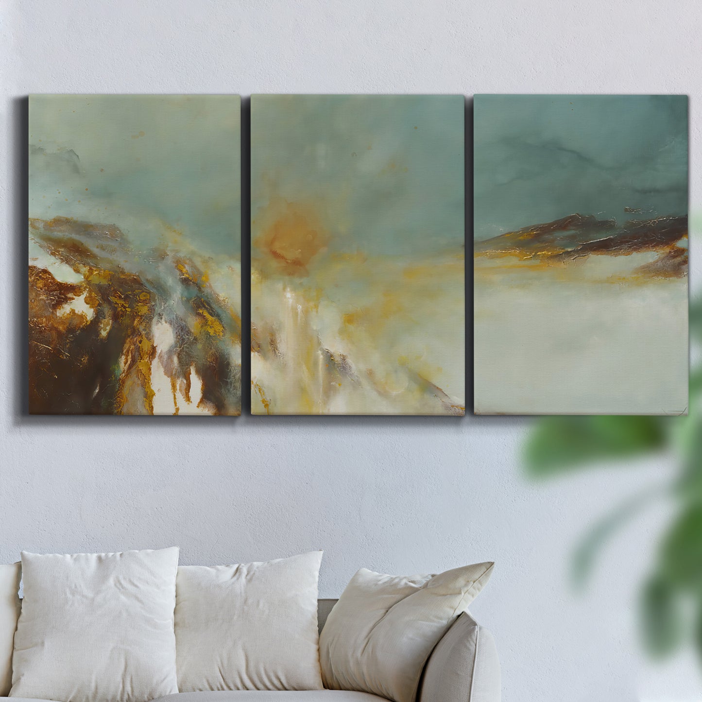 Three-panel canvas wall art featuring earth toned abstract solar landscape, displayed in a living room above a sofa.