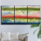 Three-panel canvas wall art featuring layered abstract color banding, displayed in a living room above a sofa.