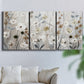 Three-panel canvas wall art featuring misty wildflower meadow landscape, displayed in a living room above a sofa.