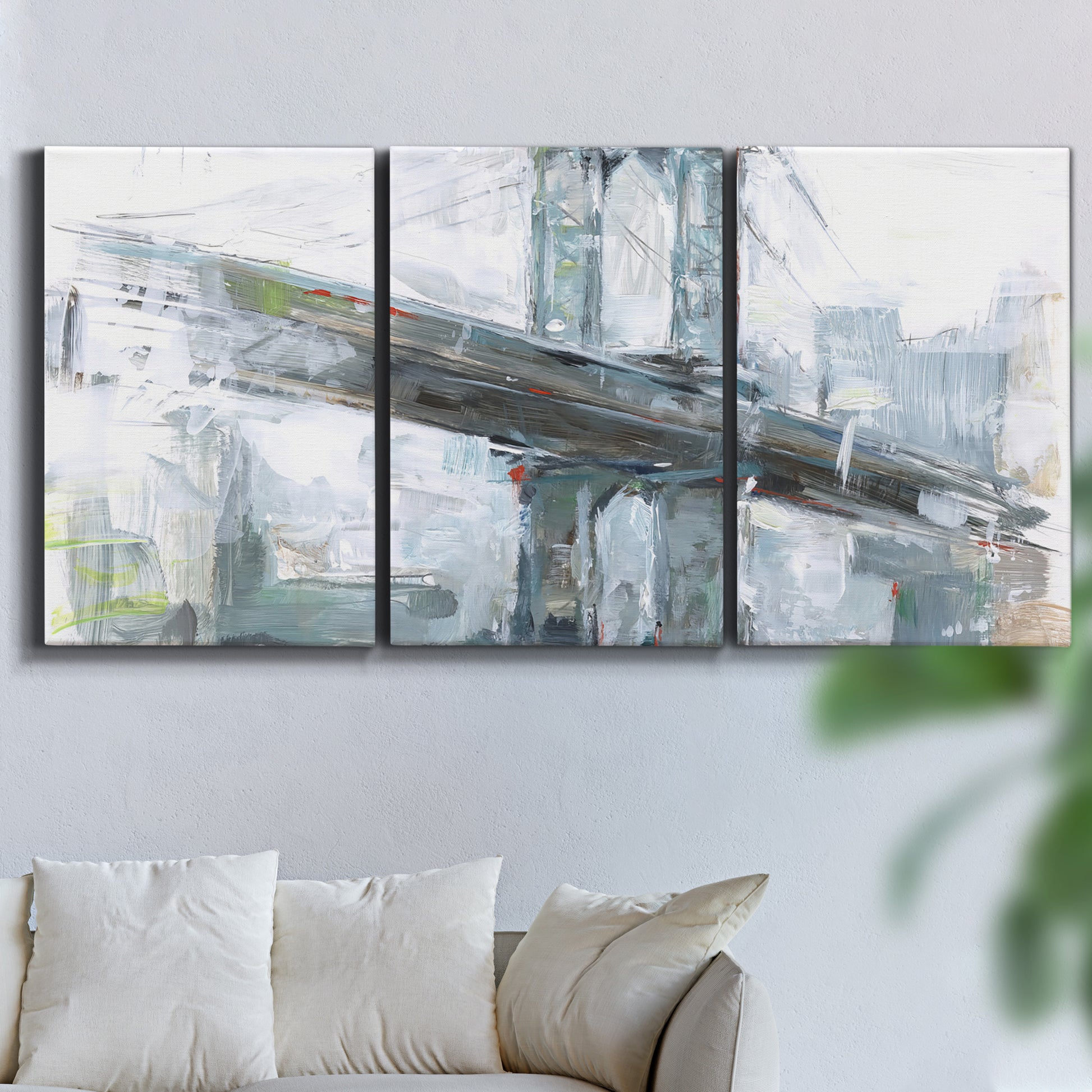 Three-panel canvas wall art featuring urban cityscape with architectural forms, displayed in a living room above a sofa.