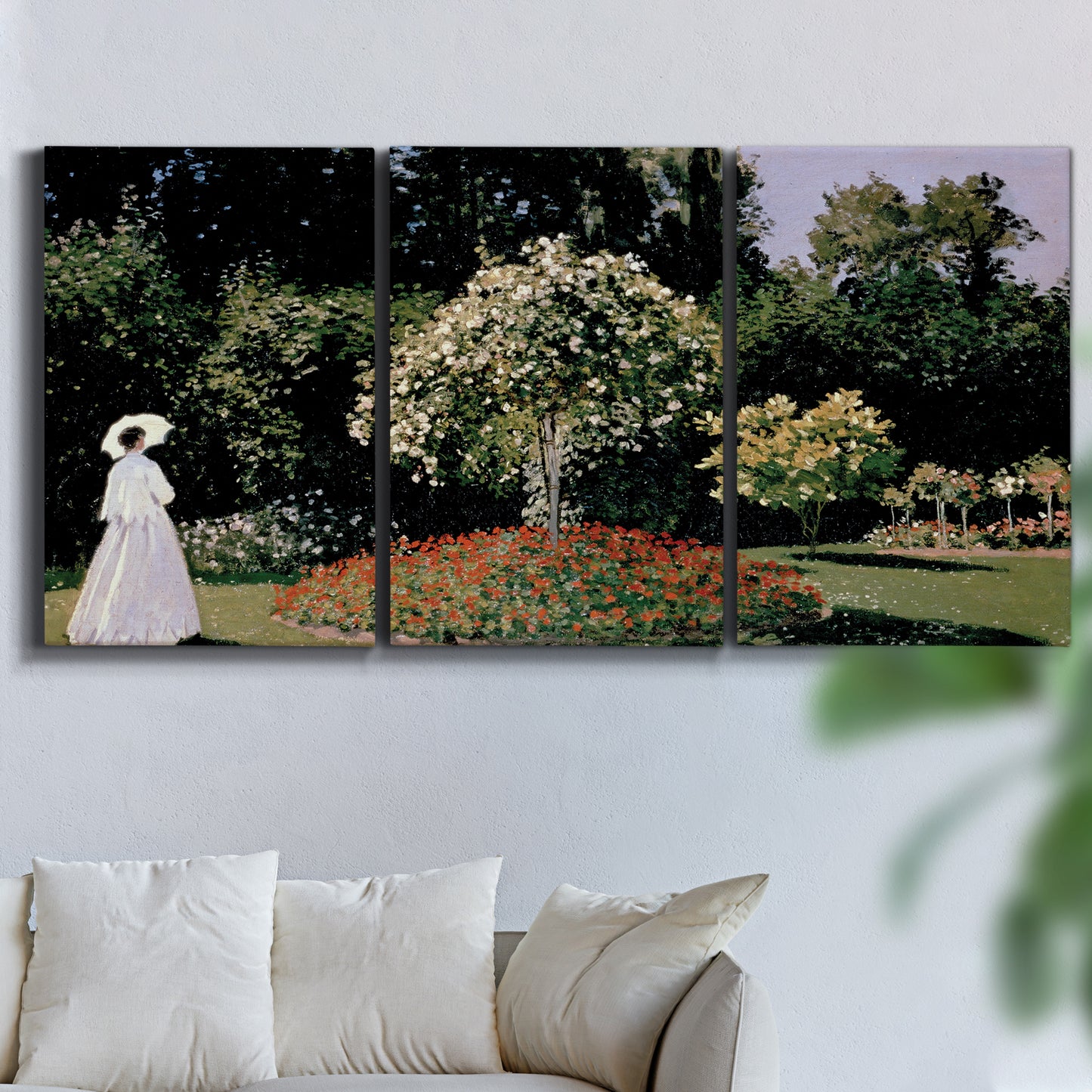 Three-panel canvas wall art featuring woman seated in garden landscape, displayed in a living room above a sofa.