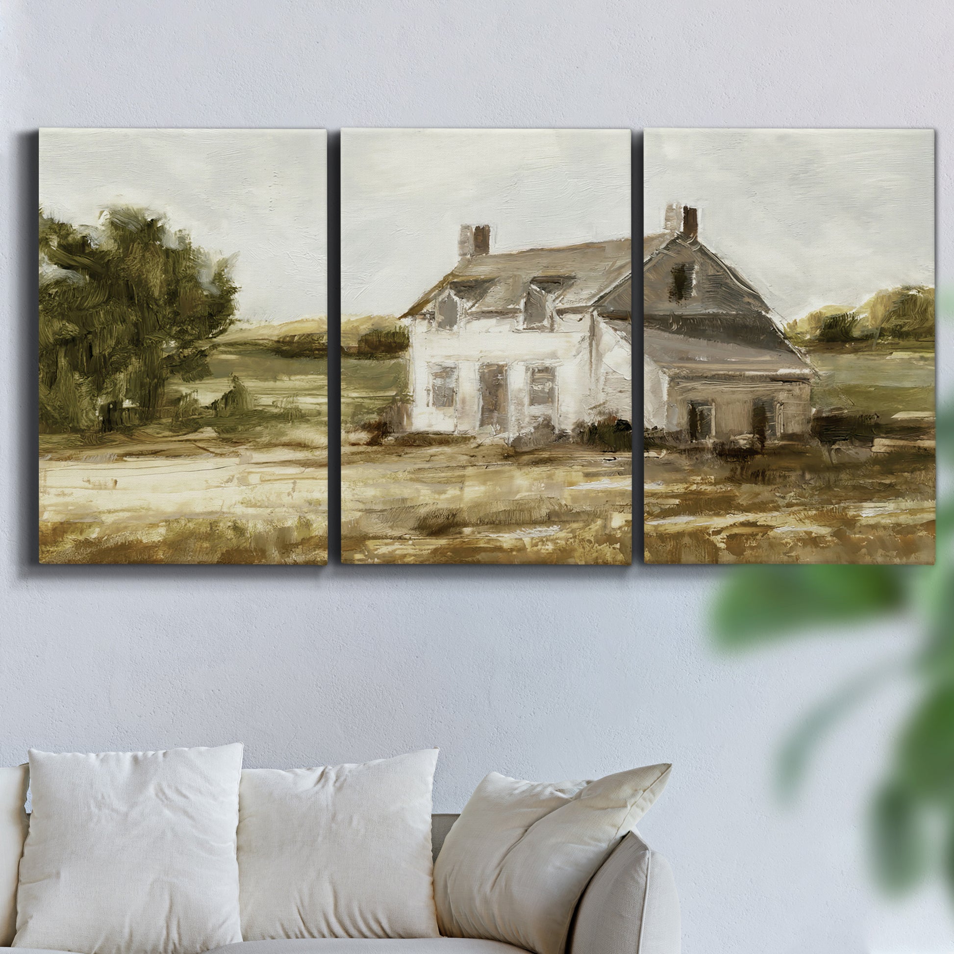 Three-panel canvas wall art featuring rural farmhouse harvest landscape, displayed in a living room above a sofa.