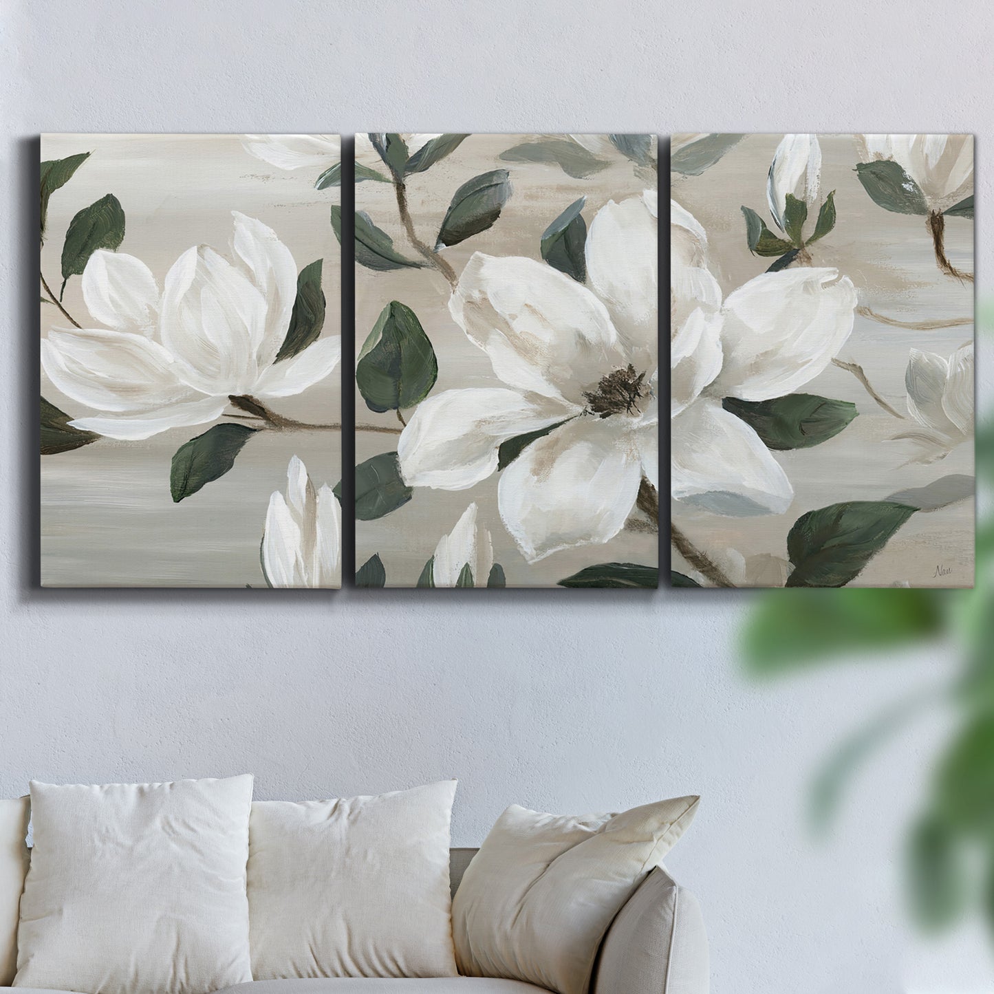 Three-panel canvas wall art featuring soft southern floral charm, displayed in a living room above a sofa.