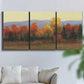 Three-panel canvas wall art featuring autumn landscape changing foliage, displayed in a living room above a sofa.