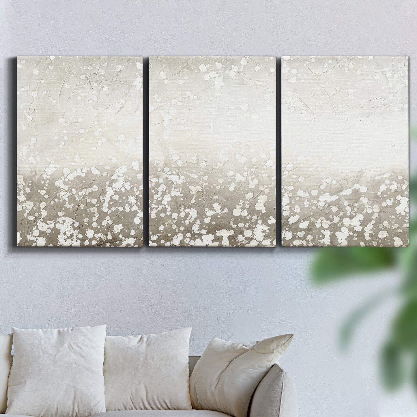 Three-panel canvas wall art featuring dark textured abstract mist, displayed in a living room above a sofa.