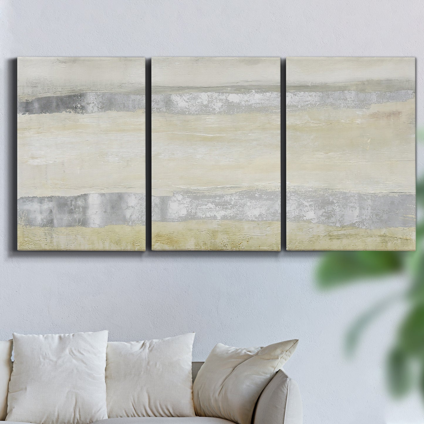 Three-panel canvas wall art featuring minimal abstract storm movement, displayed in a living room above a sofa.
