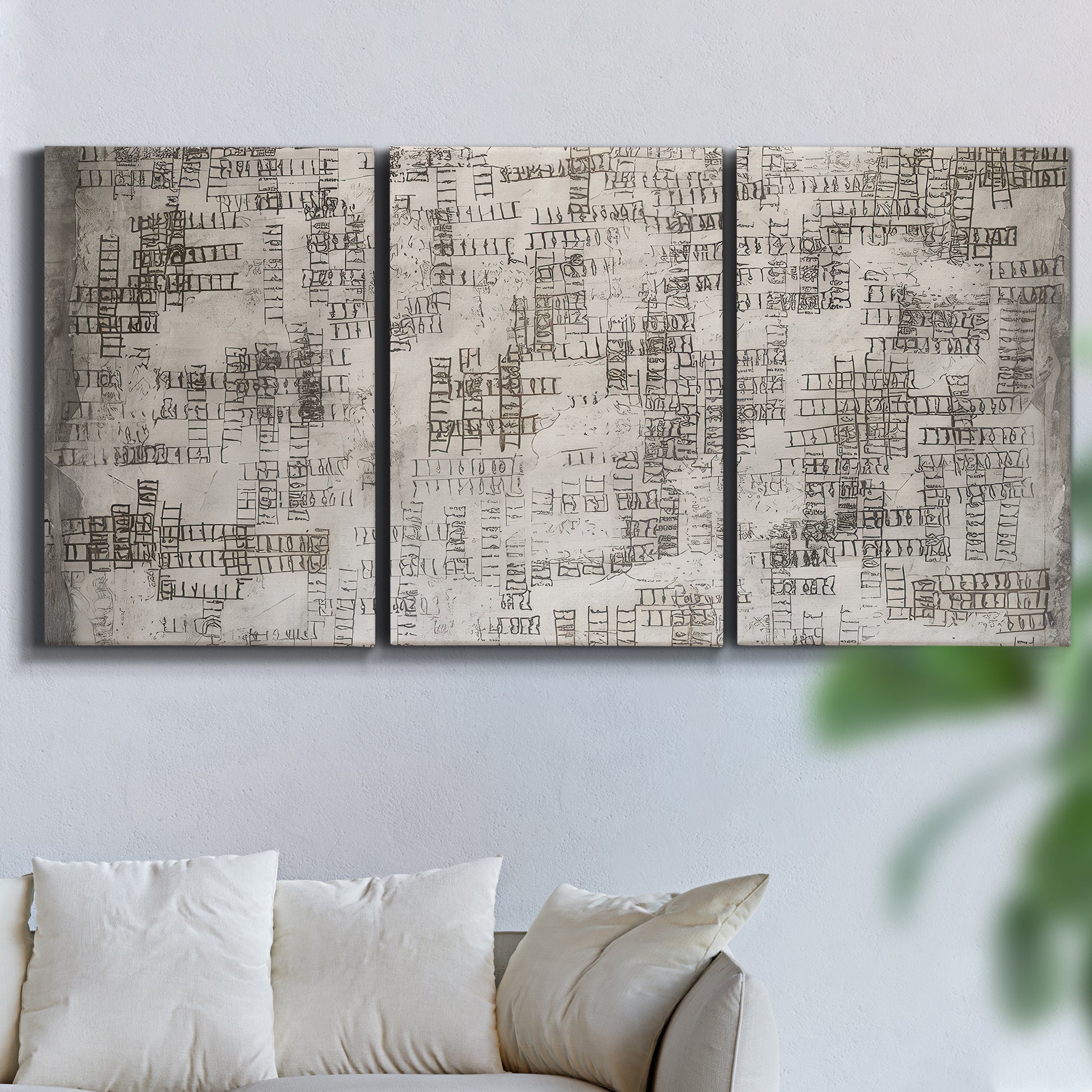Three-panel canvas wall art featuring grid based geometric abstraction, displayed in a living room above a sofa.