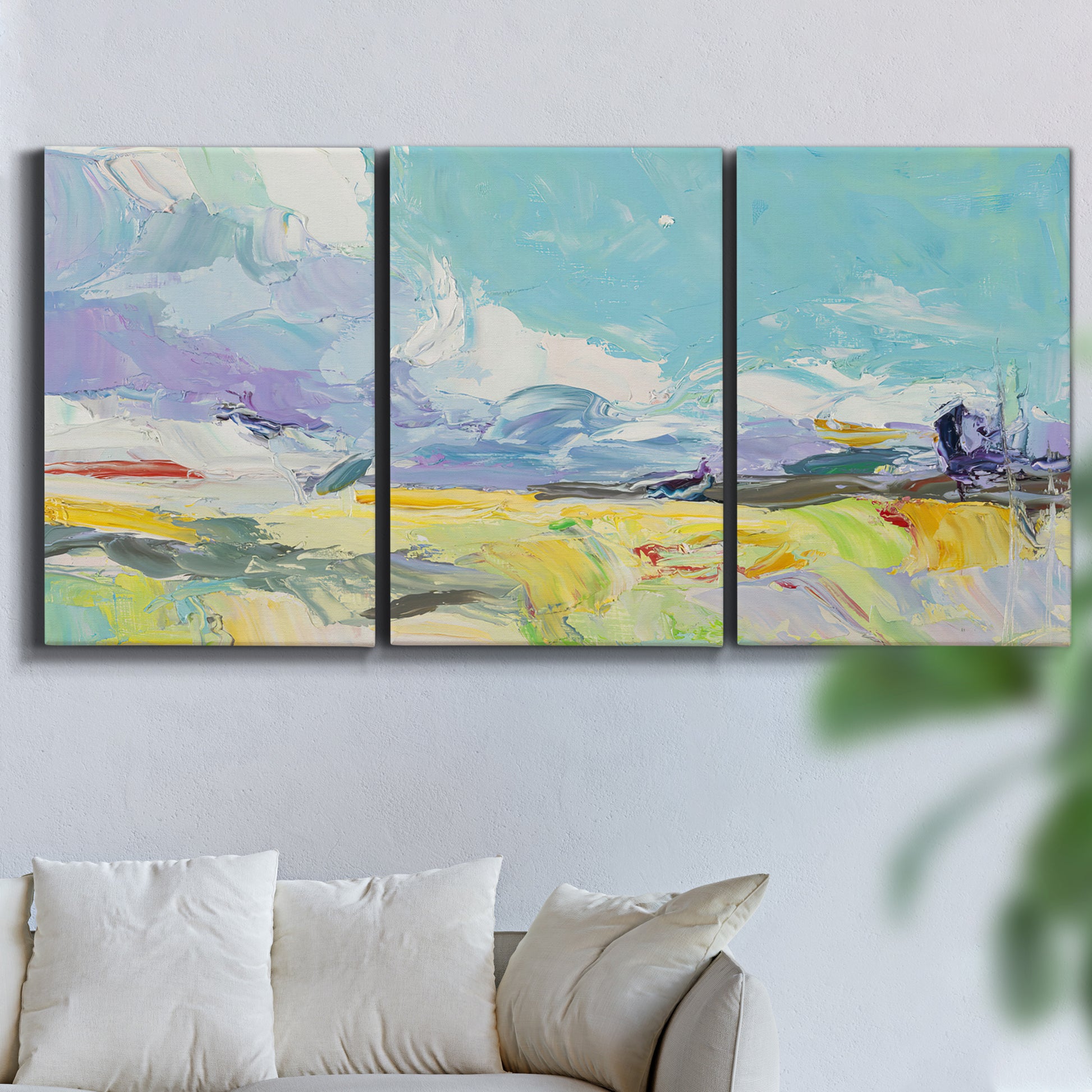 Three-panel canvas wall art featuring open landscape suggesting distant journey, displayed in a living room above a sofa.