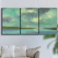 Three-panel canvas wall art featuring still lagoon water beneath open sky, displayed in a living room above a sofa.
