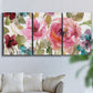 Three-panel canvas wall art featuring colorful floral watercolor composition, displayed in a living room above a sofa.
