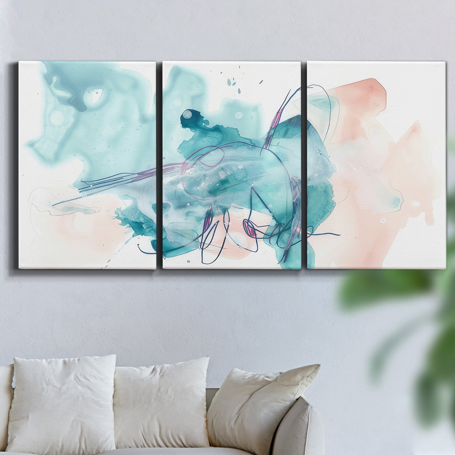 Three-panel canvas wall art featuring soft abstract watercolor forms, displayed in a living room above a sofa.