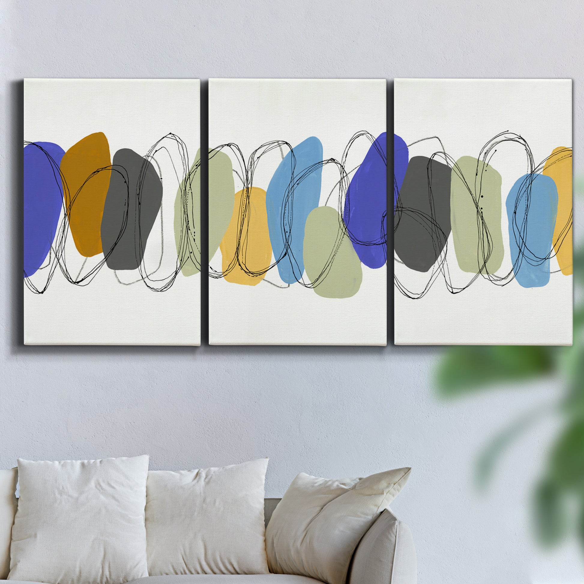 Three-panel canvas wall art featuring minimalist geometric abstract spacing, displayed in a living room above a sofa.