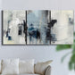 Three-panel canvas wall art featuring cool abstract winter color wash, displayed in a living room above a sofa.