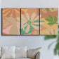 Three-panel canvas wall art featuring neutral toned botanical floral silhouettes, displayed in a living room above a sofa.