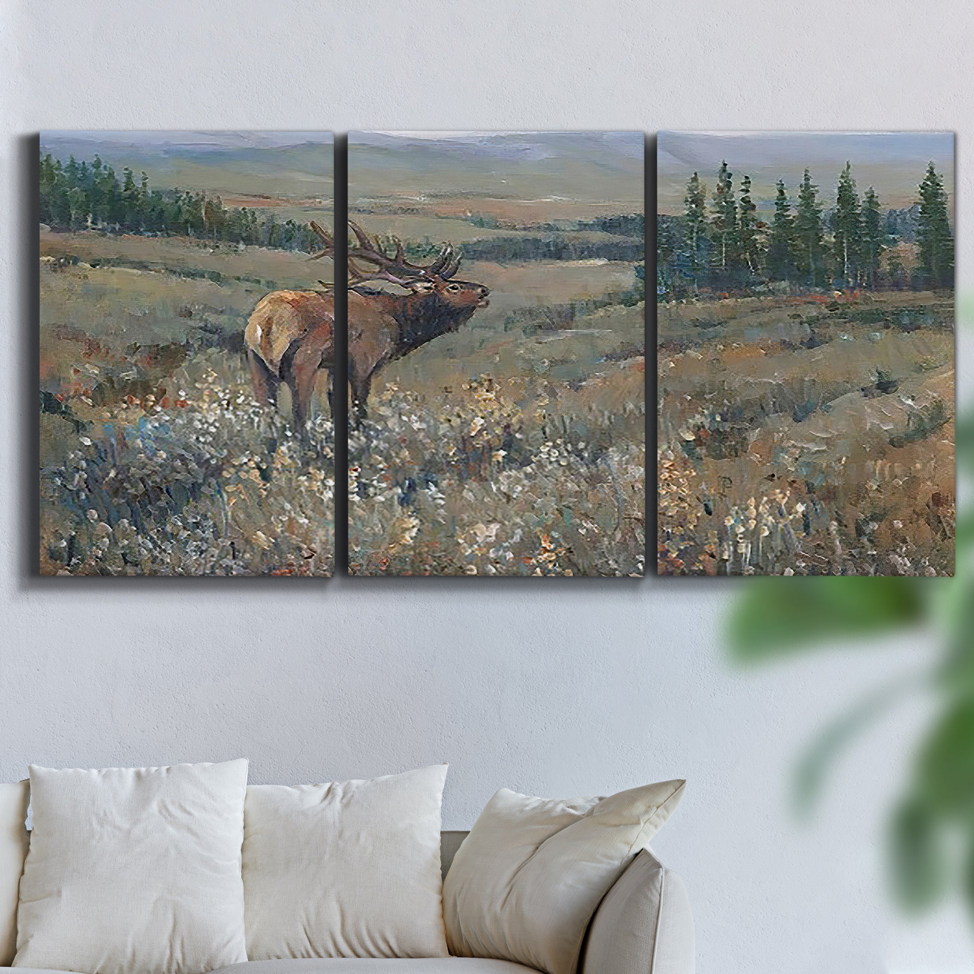 Three-panel canvas wall art featuring western wildlife grazing in open field, displayed in a living room above a sofa.
