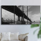 Three-panel canvas wall art featuring manhattan bridge industrial cityscape, displayed in a living room above a sofa.
