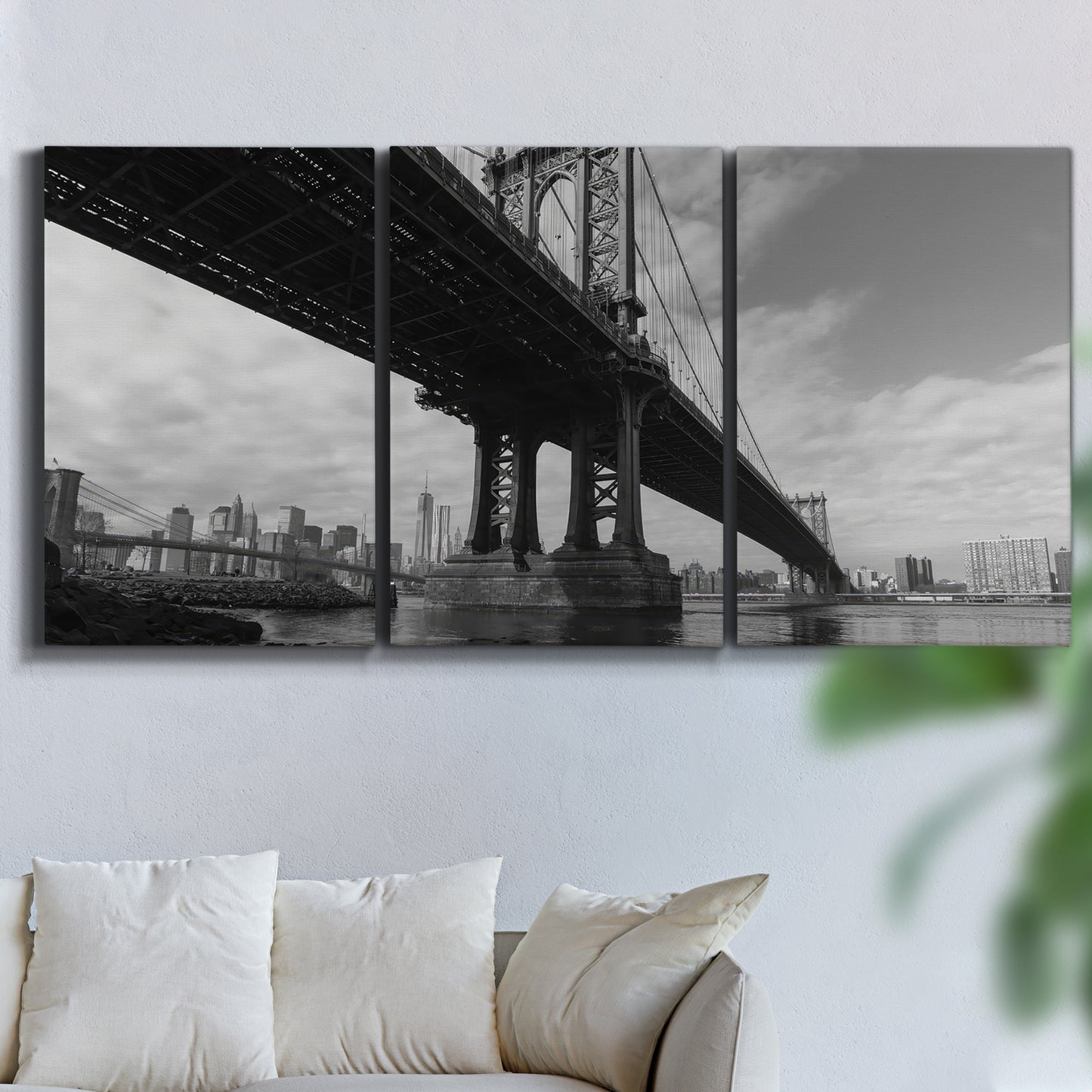 Three-panel canvas wall art featuring manhattan bridge industrial cityscape, displayed in a living room above a sofa.