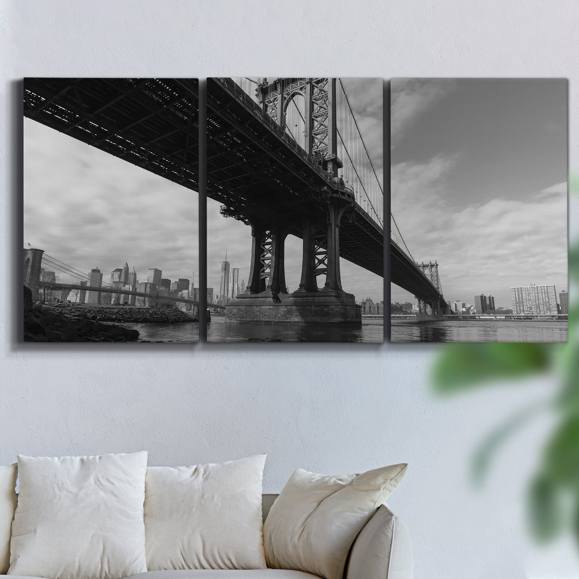 Three-panel canvas wall art featuring manhattan bridge industrial cityscape, displayed in a living room above a sofa.