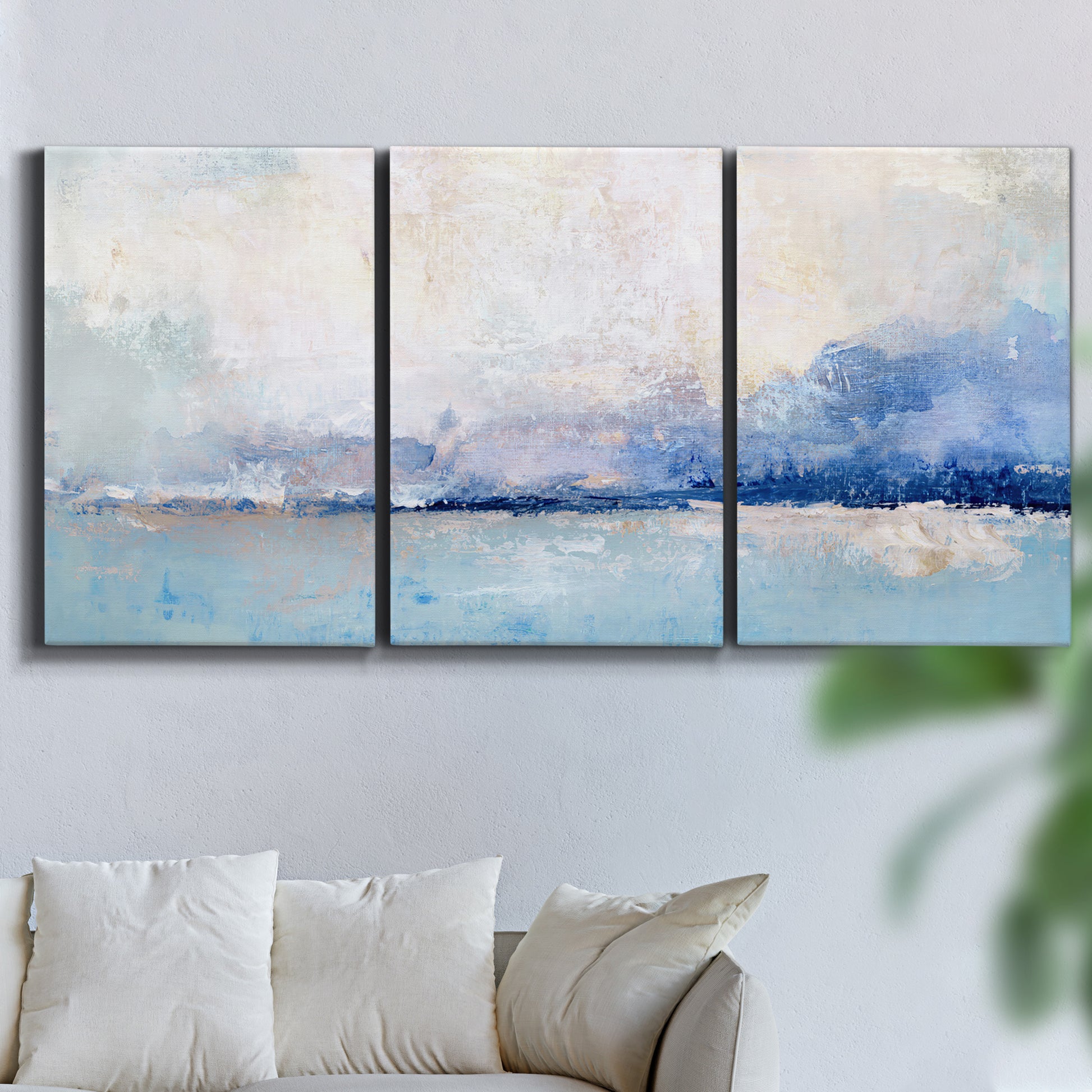 Three-panel canvas wall art featuring abstract bay with rhythmic forms, displayed in a living room above a sofa.