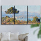Three-panel canvas wall art featuring coastal town viewed from hillside, displayed in a living room above a sofa.