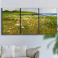 Three-panel canvas wall art featuring rugged coastal cliff landscape, displayed in a living room above a sofa.