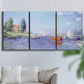 Three-panel canvas wall art featuring river flowing past riverside town, displayed in a living room above a sofa.