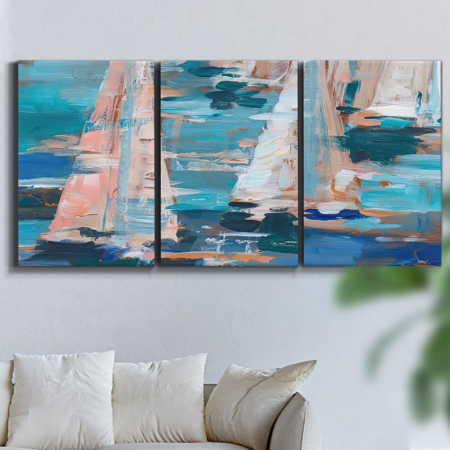Three-panel canvas wall art featuring graphic pop style sailboats, displayed in a living room above a sofa.